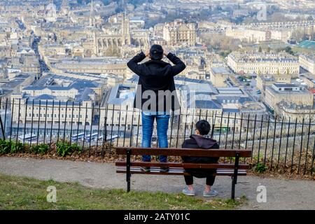 People taking advantage of the high vantage point view are pictured in Alexandra Park looking down at the city of Bath. Bath Somerset England uk Stock Photo