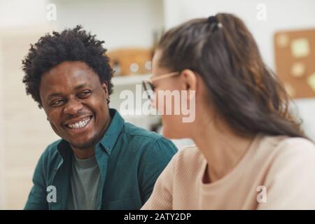 Happy multiethnic young couple talking to each other and spending funny time together Stock Photo