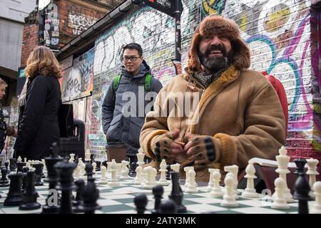 London, UK, - 23 December 2019, People play chess on Sunday in Brick lane, where the Sunday flea market usually takes place. Stock Photo