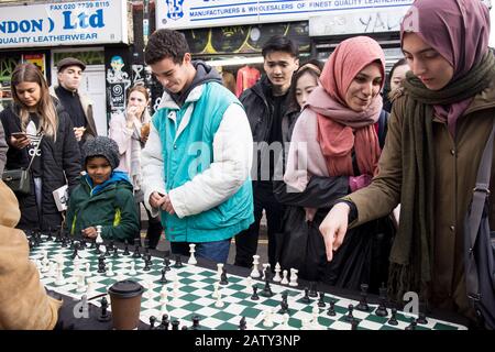 London, UK, - 23 December 2019, People play chess on Sunday in Brick lane, where the Sunday flea market usually takes place. Stock Photo