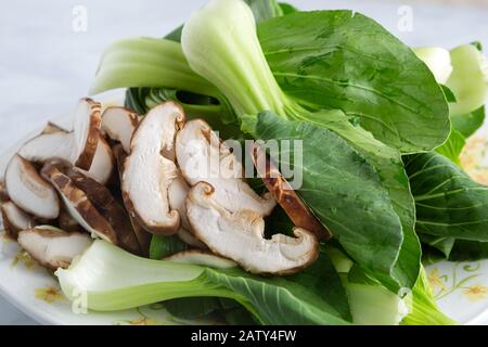 Boy choy and sliced mushrooms in prepration for cooking Chinese food Stock Photo
