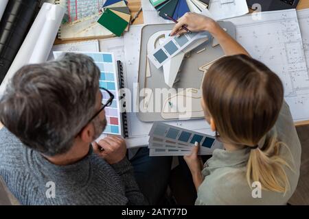 Interior designers team working in office with color palette. Architects select colors for building using color swatches, sketching and planning const Stock Photo