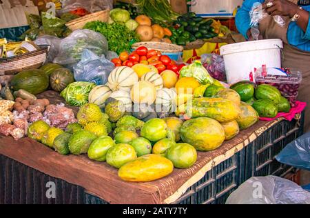 Street fruit market where locals offers tropical fruits like melons, mangoes, oranges, lemons and more. It is in Senegal, near Dakar. Stock Photo