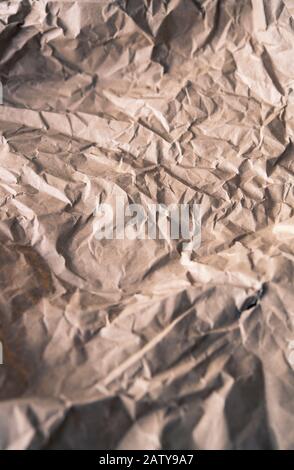 Crumpled and used piece of brown wrapping paper Stock Photo