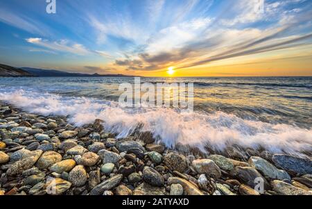 Waves of the Mediterranean sea breaking on pebble beach near Farinole Cap Corse, Corsica, France Stock Photo
