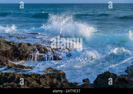 Waves crashing into rocky shore, Grand Cayman Island blowholes Stock Photo