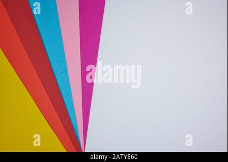 colored papers laid in a fan pattern on a white paper as background photo with copy space Stock Photo