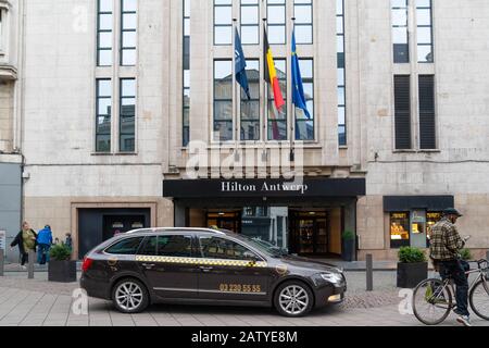 Antwerp / Belgium - October 08 2019: The entrance of the Hilton Hotel in Antwerp city with a taxi car waiting in front of the door Stock Photo