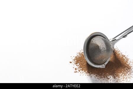 Stainless steel strainer on Chocolate powder isolated on white background Stock Photo
