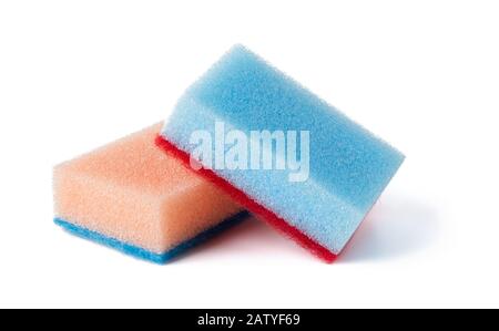 Two kitchen foam sponges of pastel orange and blue colors isolated on white background. Sponge for washing dishes and housework. Front view. Stock Photo