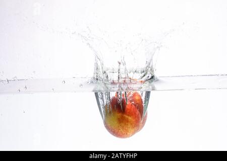 fruit in a spray of water isolated on a white background. Stock Photo