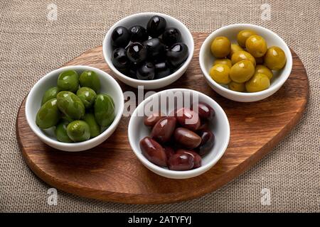 Four types of olives in bowls Stock Photo