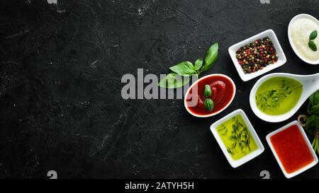 Set sauces and spices. On a wooden background. Top view. Free space for your text. Stock Photo