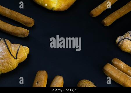 Different types of fresh bread with grain on a black rustic background. the bread stands around Stock Photo