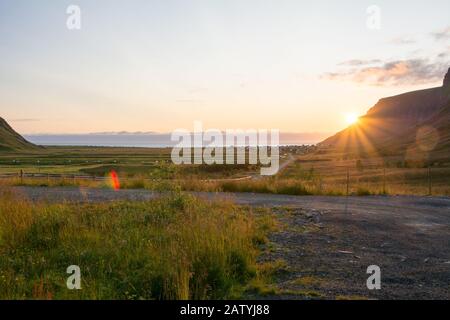 Sunset at Unstad Beach, the surfers paradise in Lofoten Islands, Norway. View on the bay from uphill. Stock Photo