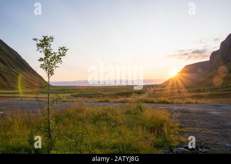 Sunset at Unstad Beach, the surfers paradise in Lofoten Islands, Norway. View on the bay from uphill. Stock Photo