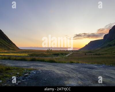 Sunset at Unstad Beach, the surfers paradise in Lofoten Islands, Norway. View on the bay from uphill. Stock Photo