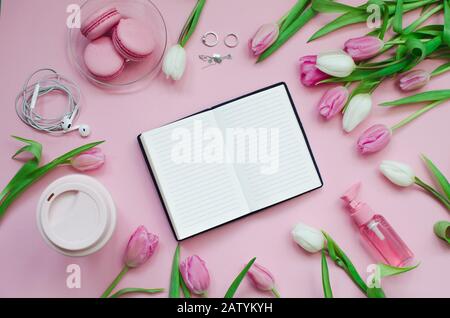 Notepad wish list for future plans. flat lay composition with flowers, a notepad, cup of coffee and sweets Stock Photo