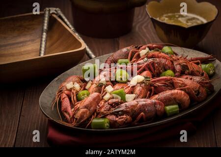 A close up of a platter of steamed crawfish and bits of peppers. Stock Photo
