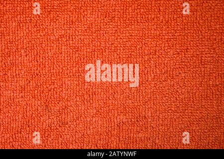 A beautiful orange natural-cotton towel background. Closeup of the grapefruit colored soft fiber texture. Amazing macro of the wonderful surface Stock Photo