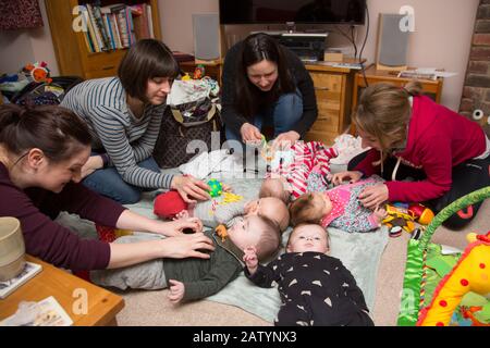A group of mothers and their babies meeting in a home, UK Stock Photo