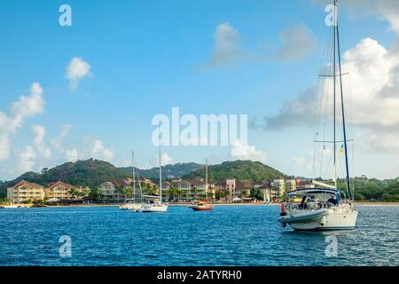 Offshore view of Rodney bay with yachts anchored in the lagoon and rich resorts in the background, Saint Lucia, Caribbean sea Stock Photo