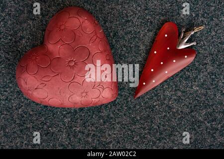 Valentine's day, two red various hearts, with flower design and strawberry heart on blue green textured background. High angle view, close up with spa Stock Photo