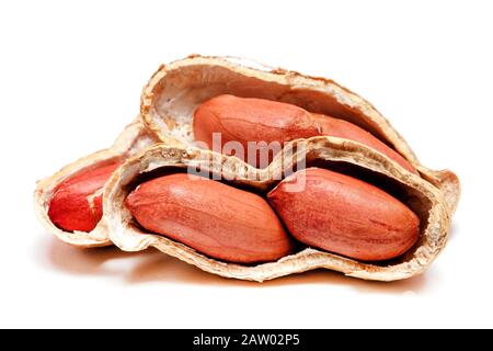Large peeled peanuts close-up of beans in the shell. Unpeeled peanuts in the shell. Peanuts, for background or texture. Growing organic protein Stock Photo