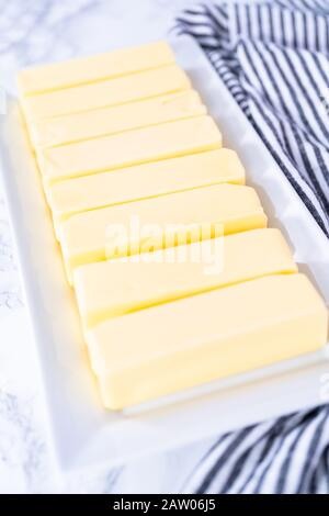 Organic sticks of butter at the room temperature. Stock Photo