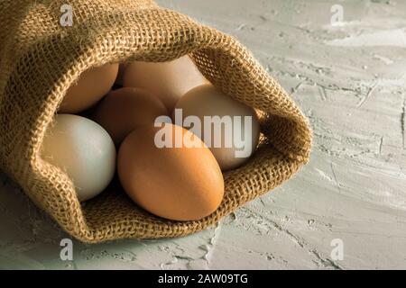 No plastic sackcloth, close up plastic free, brown and white eggs in eco bag, copy space food Stock Photo