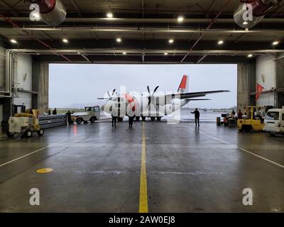 A Coast Guard Air Station Sacramento C-27J aircrew visits the hanger at Coast Guard Air Station Astoria, Oregon, Jan. 22, 2020. The C-27Js are outfitted with weather radar and communications equipment capable of supporting transport and other Coast Guard missions. U.S. Coast Guard photo by Petty Officer 3rd Class Trevor Lilburn. Stock Photo