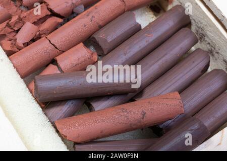 Russian sanguine and sepia and red drawing sticks in a wooden box Stock Photo