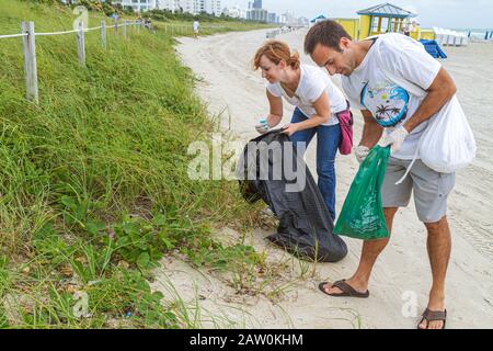 Miami Beach Florida,Coastal Cleanup Day,volunteer volunteers volunteering work worker workers,teamwork working together serving help lending,helping l Stock Photo