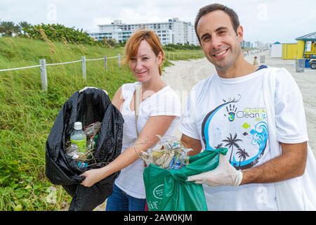 Miami Beach Florida,Coastal Cleanup Day,volunteer volunteers volunteering work worker workers,teamwork working together serving help lending,helping l Stock Photo