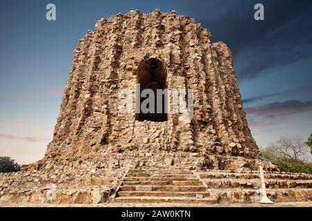 Big ruined tower at Qutub Minar complex in New Delhi, India at purple sunset Stock Photo