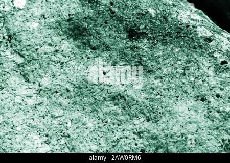 Seashore rocks texture close-up. Natural stone background green color toned Stock Photo