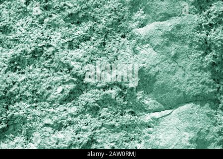 Seashore rocks texture close-up. Natural stone background green color toned Stock Photo
