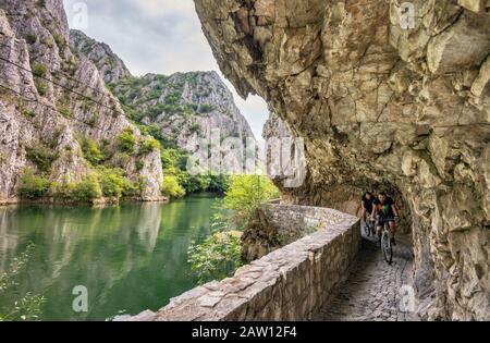 Mountain bikers at path over Matka Lake in Matka Canyon near Skopje, North Macedonia