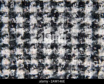 Full frame knitted warm black and white scarf as a backdrop.  Stock Photo