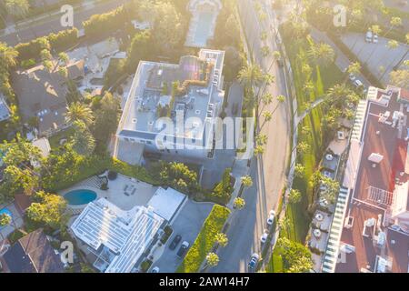 Top down aerial view of Beverly Hills neighborhood, Beverly Hills Hotel, and Sunset Boulevard surrounded with palm trees in Los Angeles, California. Stock Photo