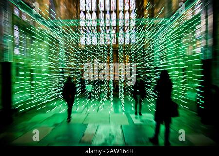 People watch 'Where There is Light' light artwork installed in the Lady Chapel at Gloucester Cathedral, consisting of hundreds of individual lights which mimic the colours of a rainbow, during a narrative and music, designed by digital arts group, Squidsoup. Stock Photo