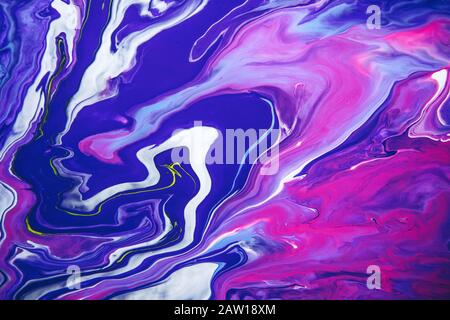 Acrylic paint liquid in trend purple and blue color mix background. Stock Photo