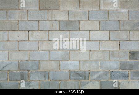 Gray brick concrete wall background. Texture of concrete bricks or blocks for construction. Stone and industrial patterns. Stock Photo