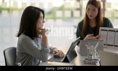 Cropped shot of female application developer presenting UI project to her headman in modern meeting room Stock Photo
