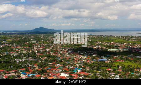 Tacloban city, Leyte island, Philippines. Tropical landscape with panorama of the town, view from above. Town and sky with cumulus clouds. Summer and travel vacation concept. Stock Photo