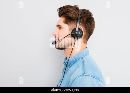 side view photo of young agent of call-centre with headphones Stock Photo