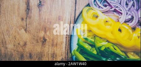 Meal for vegan concept. Sliced vegetables on a plate on a wooden table. Stock Photo