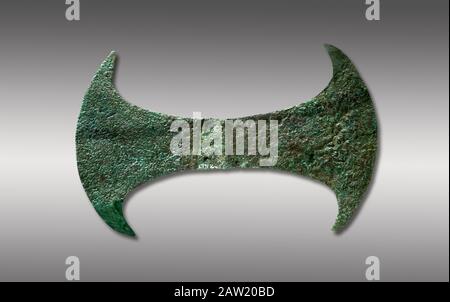 Minoan  cult bronze double axe 'labrys',  1600-1400 BC, Heraklion Archaeological  Museum, grey background.  In Minoan Crete, the double axe was an imp Stock Photo