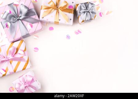 Several gift boxes with bows and confetti on a white background. Stock Photo