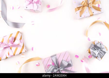 Several gift boxes with bows and confetti on a white background. Stock Photo
